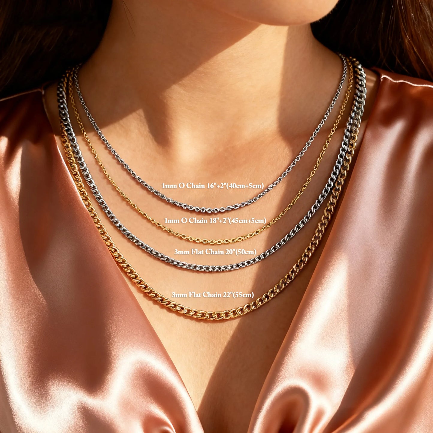 Necklace with four different chain lengths displayed on a person wearing a satin top.
