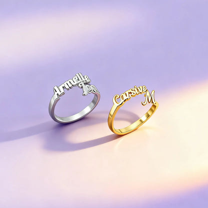 Gold and silver personalized name rings in cursive on satin background