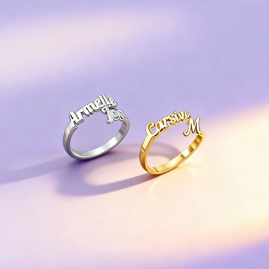 Gold and silver personalized name rings in cursive on satin background