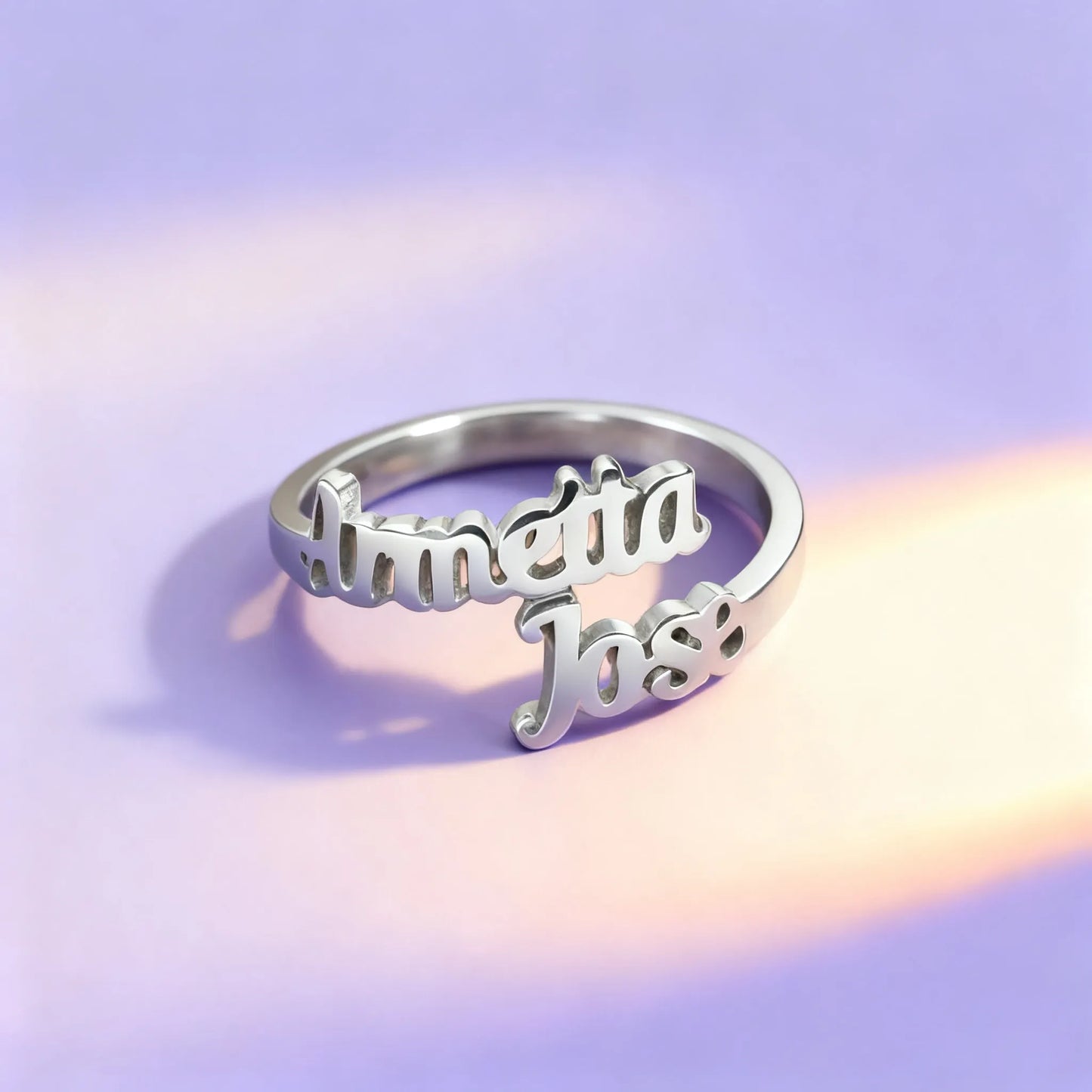 Silver personalized name ring with cursive lettering on fabric
