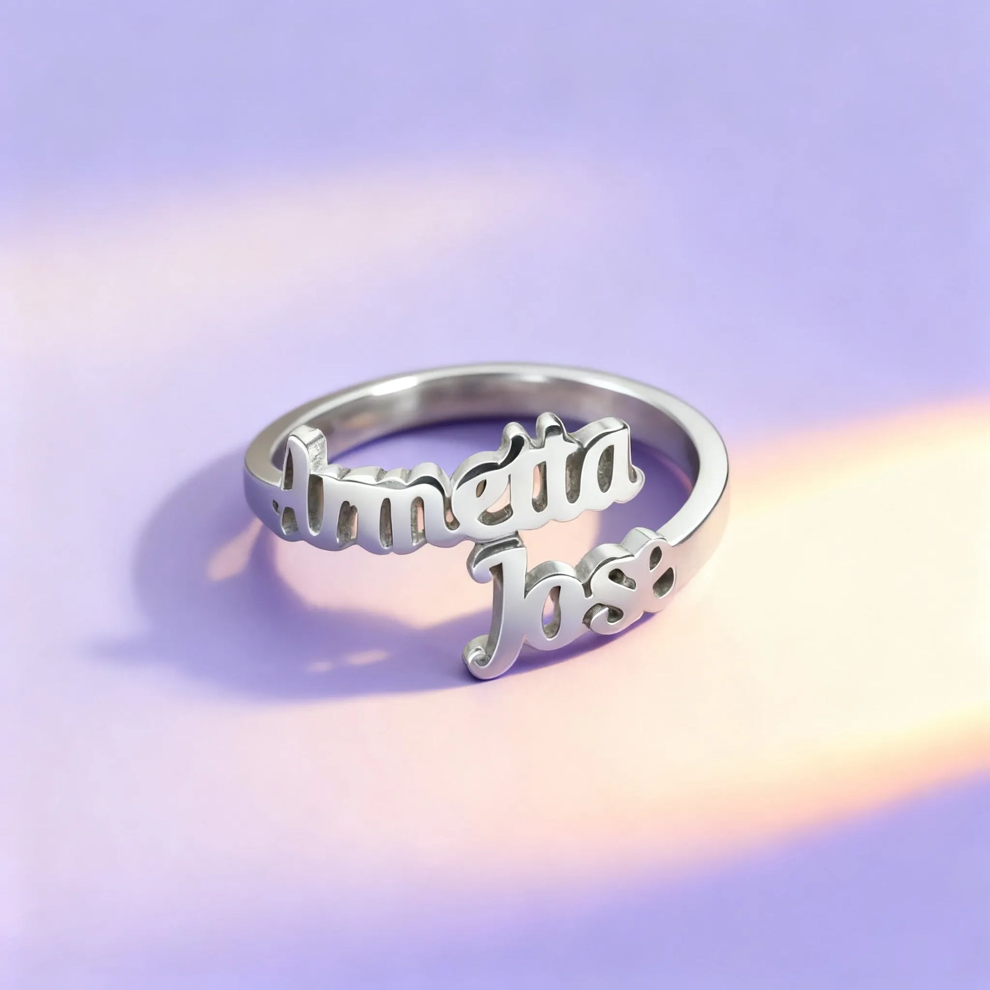 Silver personalized name ring with cursive lettering on fabric
