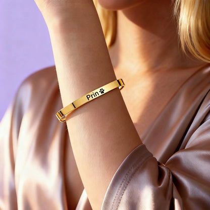 Woman wearing custom name engraved gold cuff bracelet