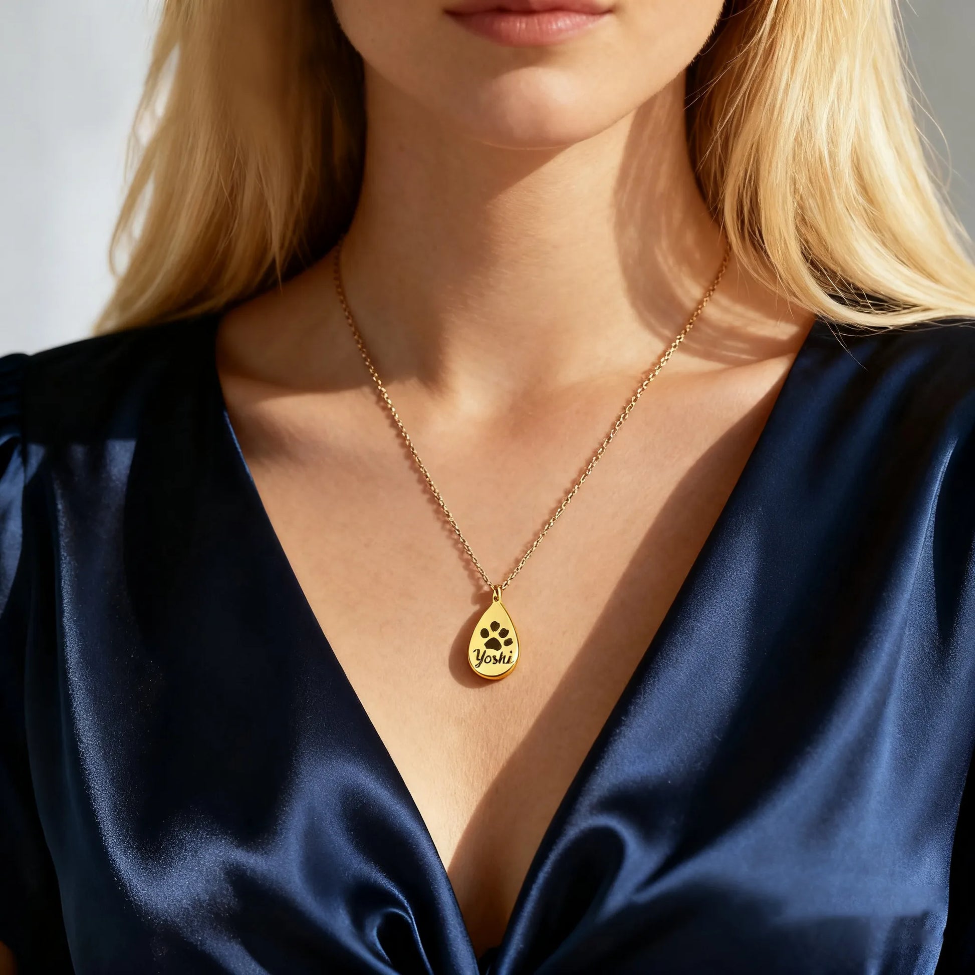 Model wearing gold teardrop pet ashes urn necklace — custom engraved memorial pendant