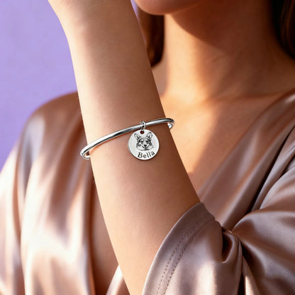 Woman wearing custom pet portrait round-charm open bangle (silver)