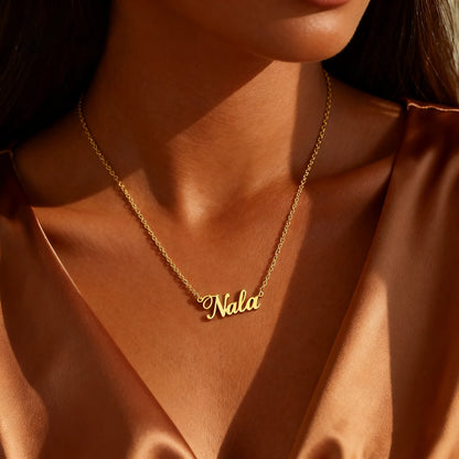 Model wearing gold custom name necklace in minimalist cursive script