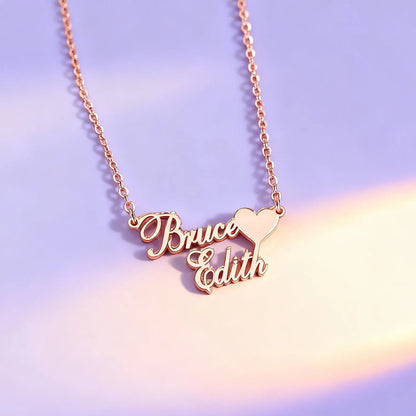 Close-up of custom double-name heart name necklace on gold chain, pastel background