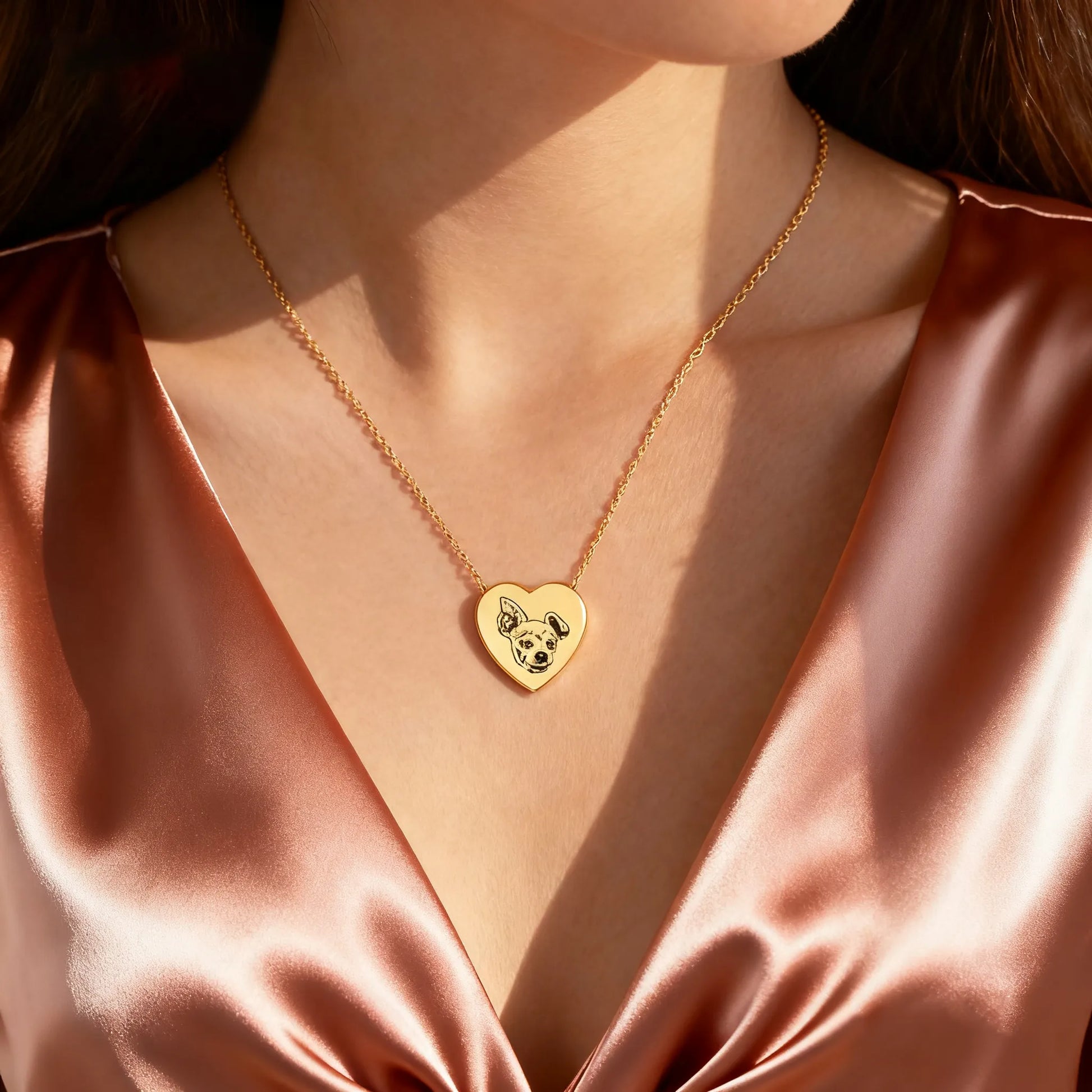 Model wearing gold heart pet cremation urn necklace — engraved memorial ashes locket
