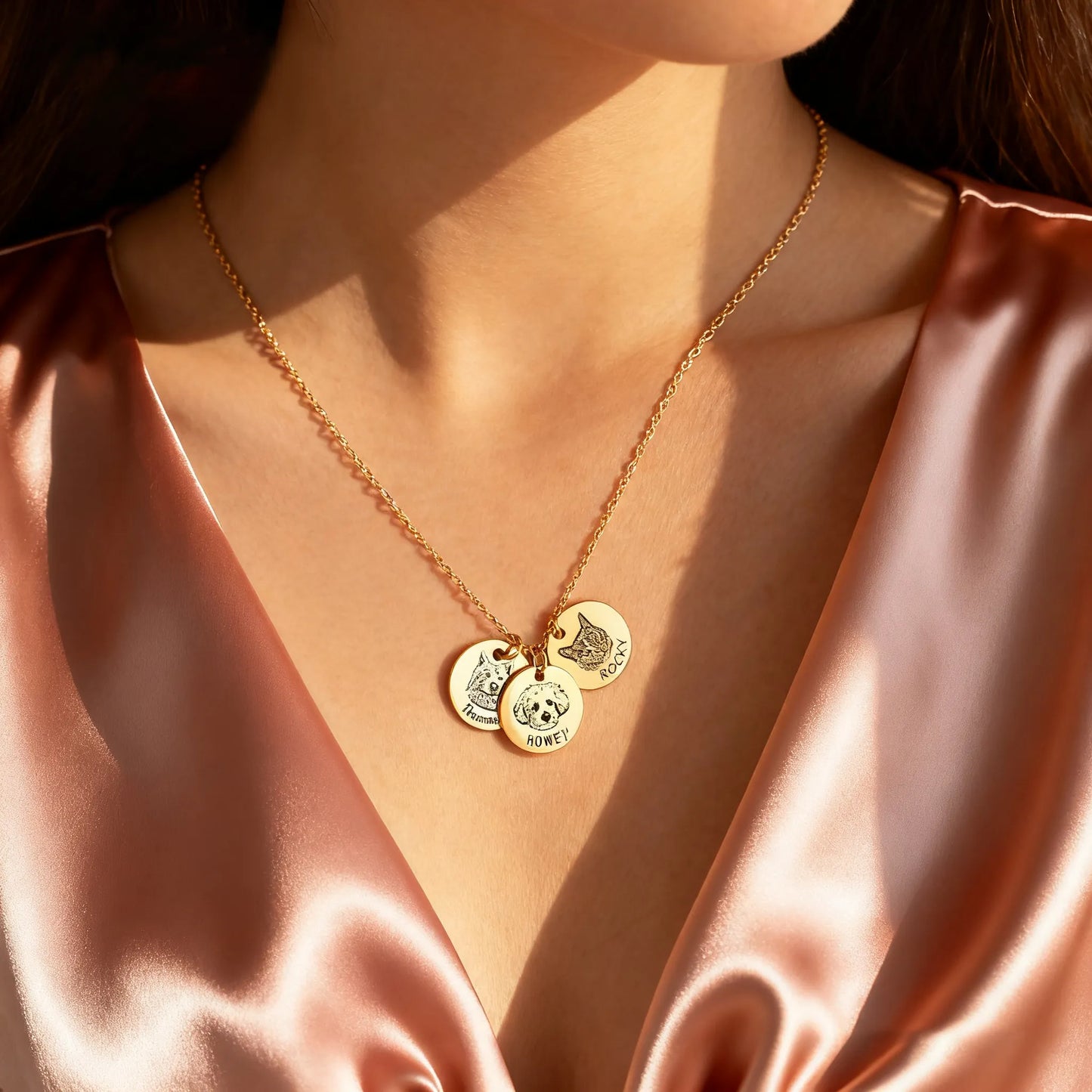 Model wearing gold custom pet portrait coin necklace with two engraved discs