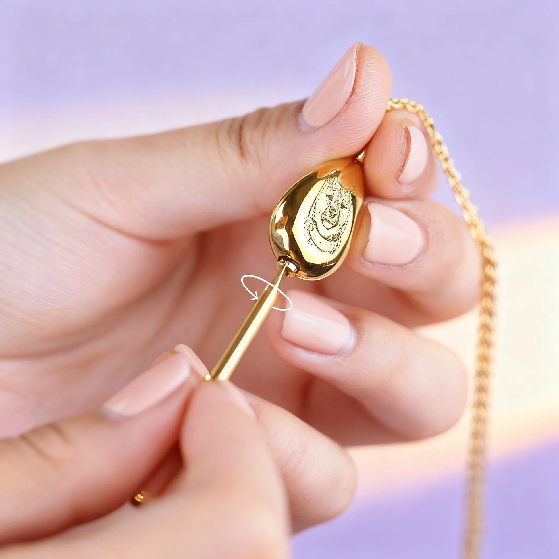 Hand opening gold teardrop pet ashes urn pendant — secure screw-top design