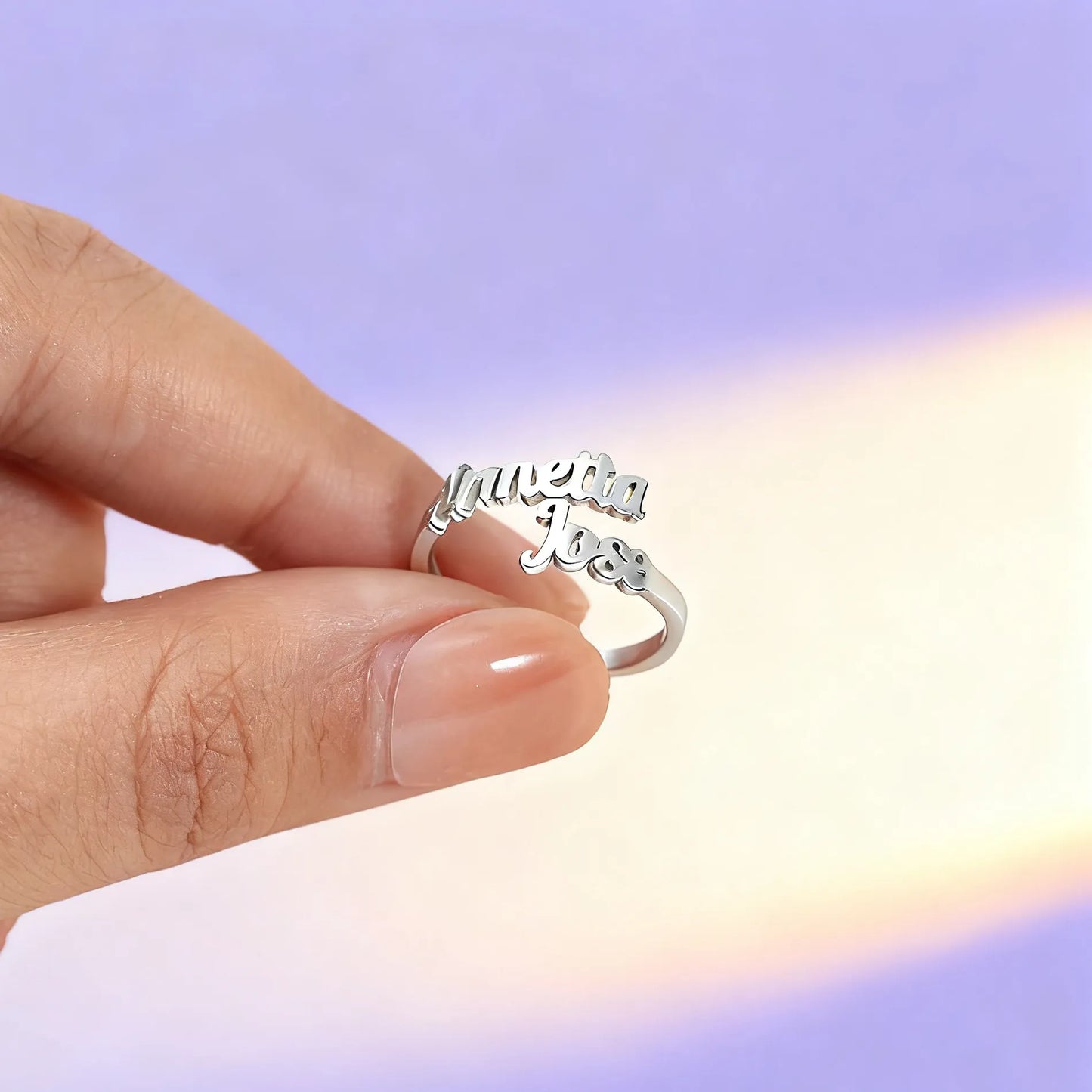 Close-up of adjustable custom name ring being held by hand