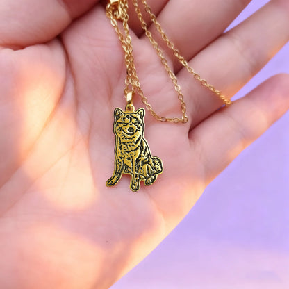 Hand-held gold custom pet silhouette necklace — dog/cat outline from your photo
