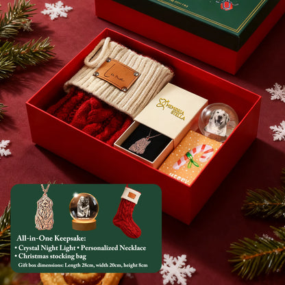Open Christmas gift box with green lid and contents: crystal night light, pet necklace, stocking, brooch